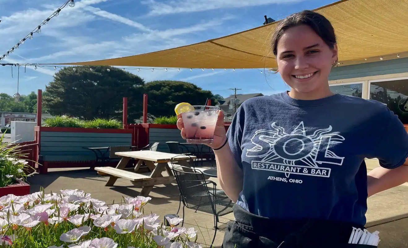 A picture of Kattie holding one of our specialty drinks